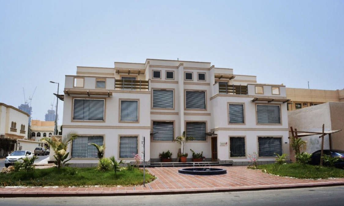 Residential building façade, garden and entrance fountain